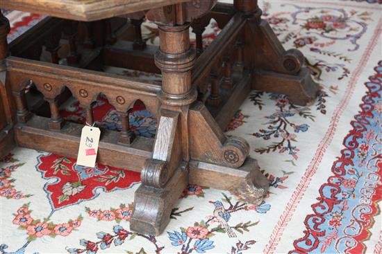 A Victorian gothic revival oak centre table, designed by Collier & Plucknett, Warwick, W.5ft D.5ft H.2ft 7in.